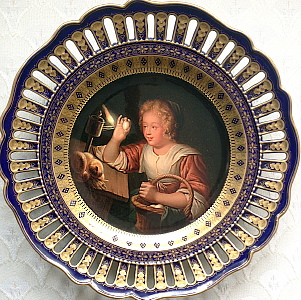 Meissen plate with old masters painting within dark cobalt blue reticulated border. Woman with egg